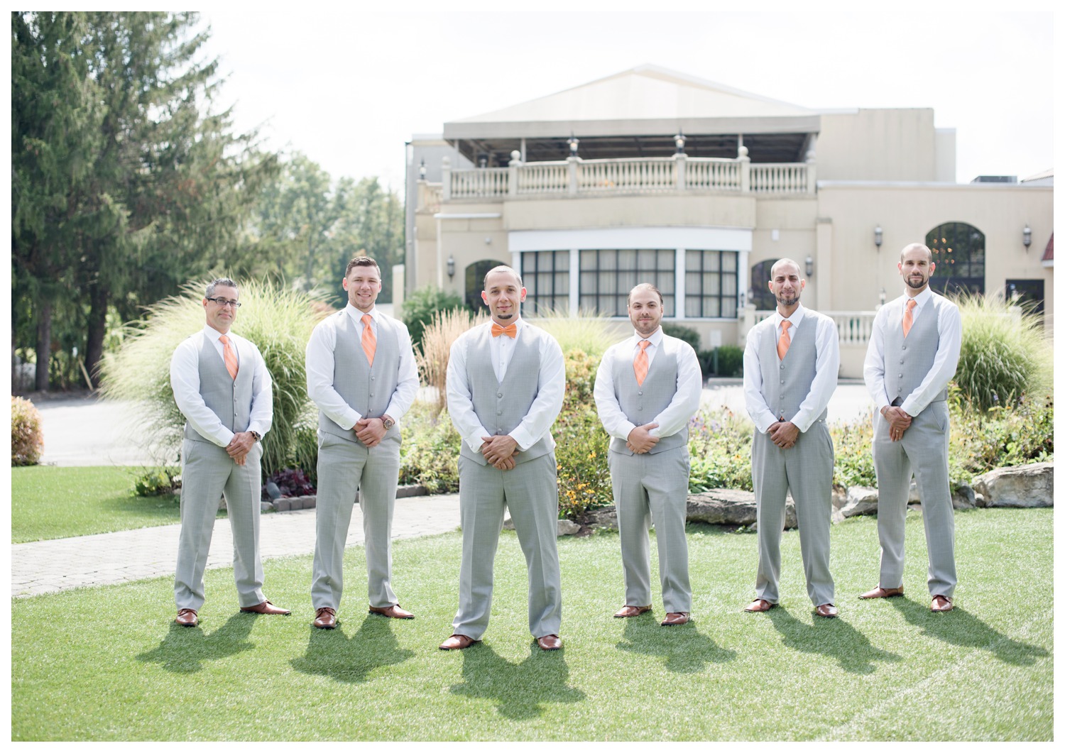 groom with bowtie on and groomsmen with ties on